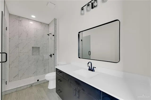 a bathroom with a bathtub shower sink and toilet