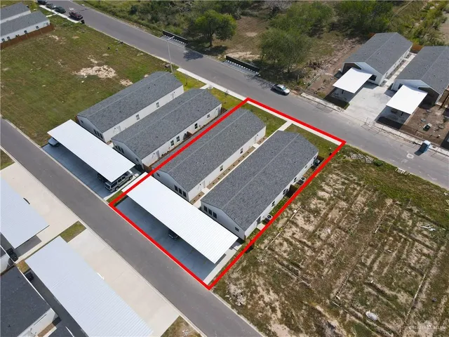 an aerial view of residential houses with outdoor space