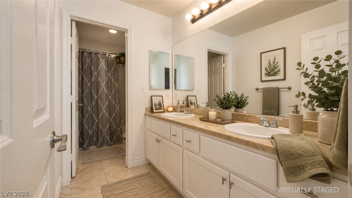 87 Tall Ruff Drive Las Vegas, NV 89148 - Photo 67 of 71 Dual vanity sinks grace this well-appointed bathroom with ample counter space and storage.