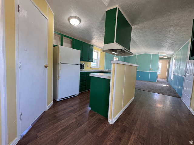 2491 Highway 89, Unit 315 Pleasant View, UT 84404 - Photo 20 of 34 Kitchen featuring wood-finish flooring, green cabinetry, white appliances, and a white countertop