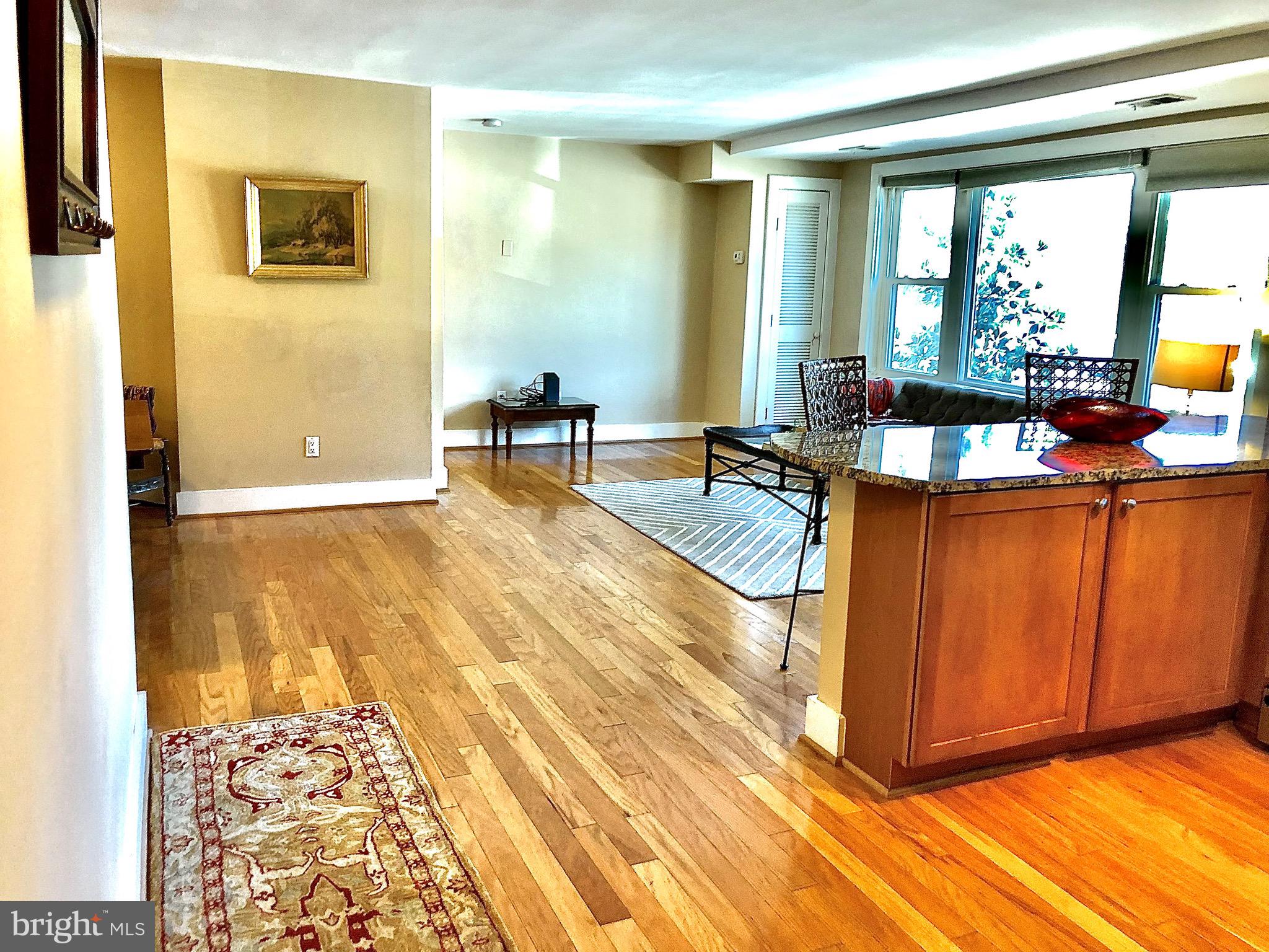 4840 MacArthur Boulevard Northwest, Unit 501 Washington, DC 20007 - Photo 2 of 24 a living room with a couch and a table