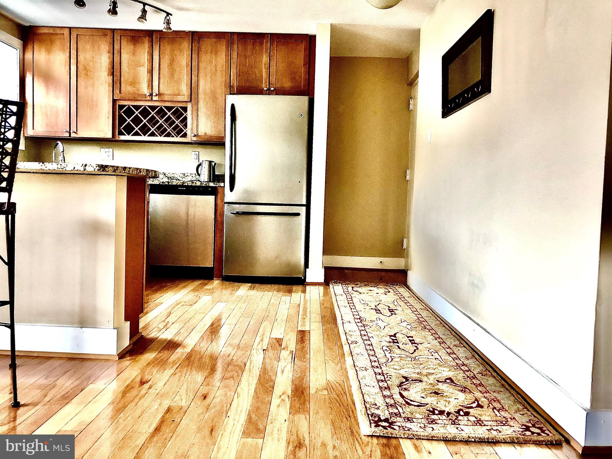 4840 MacArthur Boulevard Northwest, Unit 501 Washington, DC 20007 - Photo 8 of 24 a kitchen with a refrigerator and a cabinets