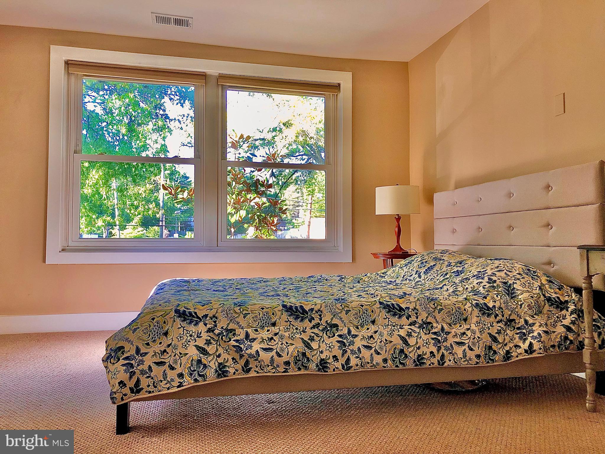 4840 MacArthur Boulevard Northwest, Unit 501 Washington, DC 20007 - Photo 10 of 24 a bed sitting in a bedroom next to a window