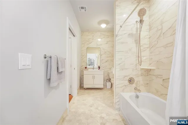 a bathroom with a bathtub and a shower
