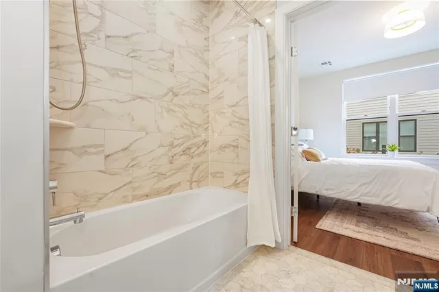 a bathroom with a bathtub and a shower