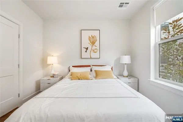 a bedroom with a large bed and a window