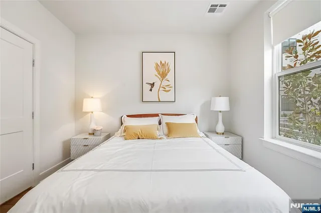 a bedroom with a large bed and a window