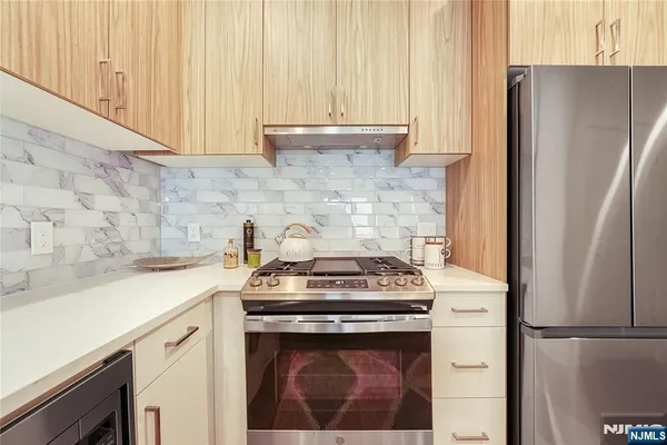 a white stove top oven sitting inside of a kitchen