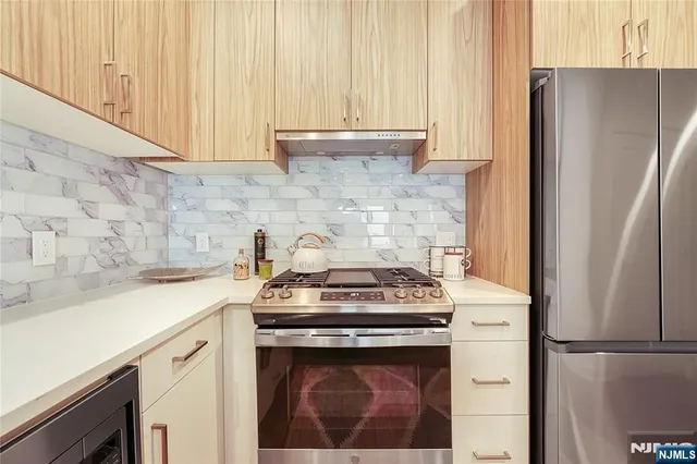a white stove top oven sitting inside of a kitchen