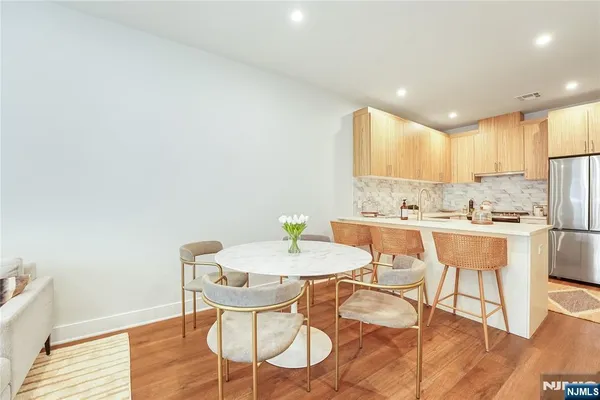 a view of a dining room with furniture and wooden floor