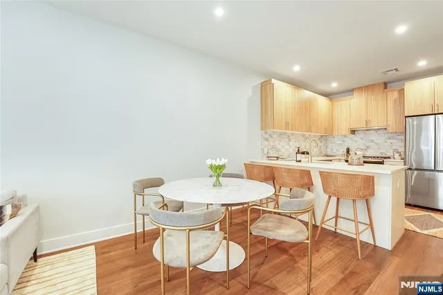 a view of a dining room with furniture and wooden floor