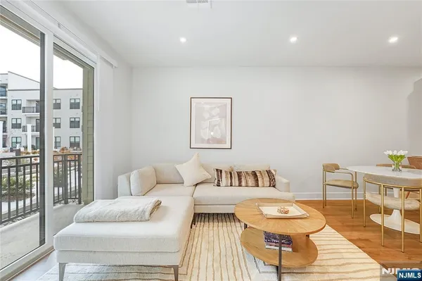 a bedroom with furniture and a large window