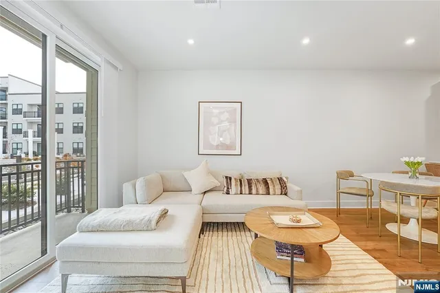 a bedroom with furniture and a large window