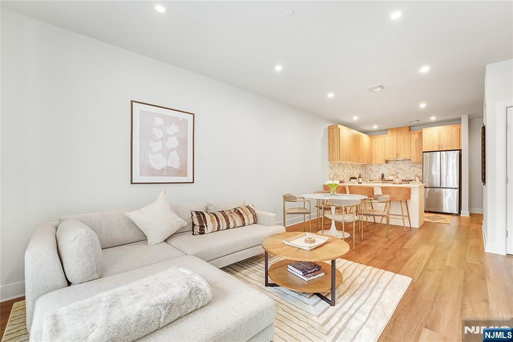 434 Springfield Avenue, Unit 105 Berkeley Heights, NJ 07922 - Photo 9 of 19 a living room with furniture and wooden floor