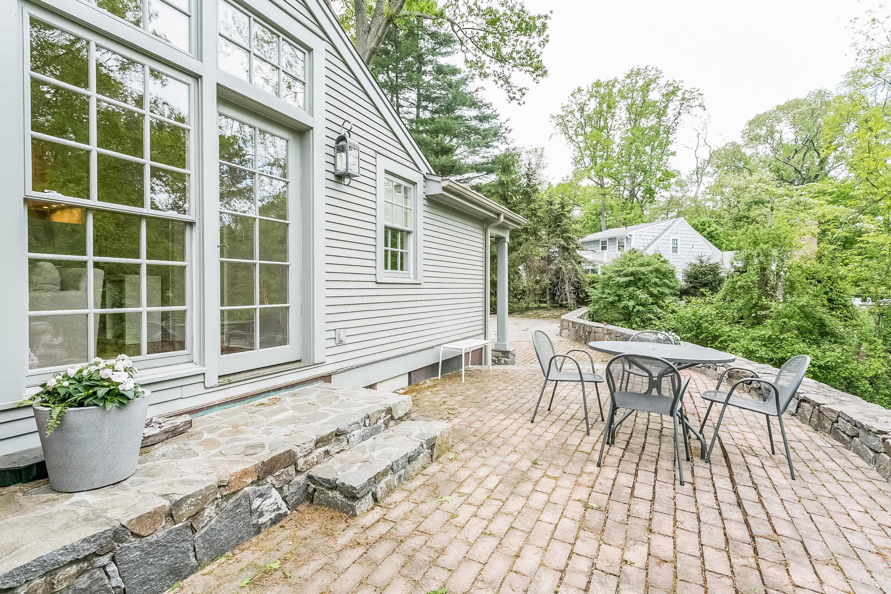 33 Tory Hole Road Darien, CT 06820 - Photo 17 of 24 a view of a patio with a table and chairs
