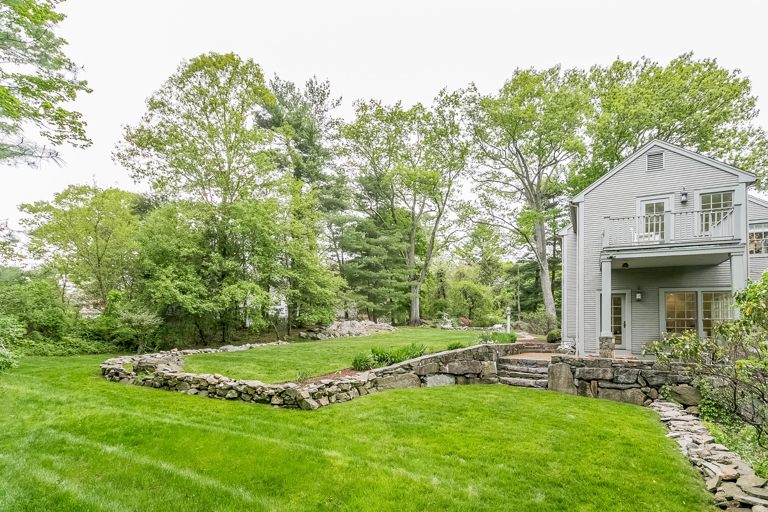 33 Tory Hole Road Darien, CT 06820 - Photo 18 of 24 a view of a house with a big yard potted plants and large tree