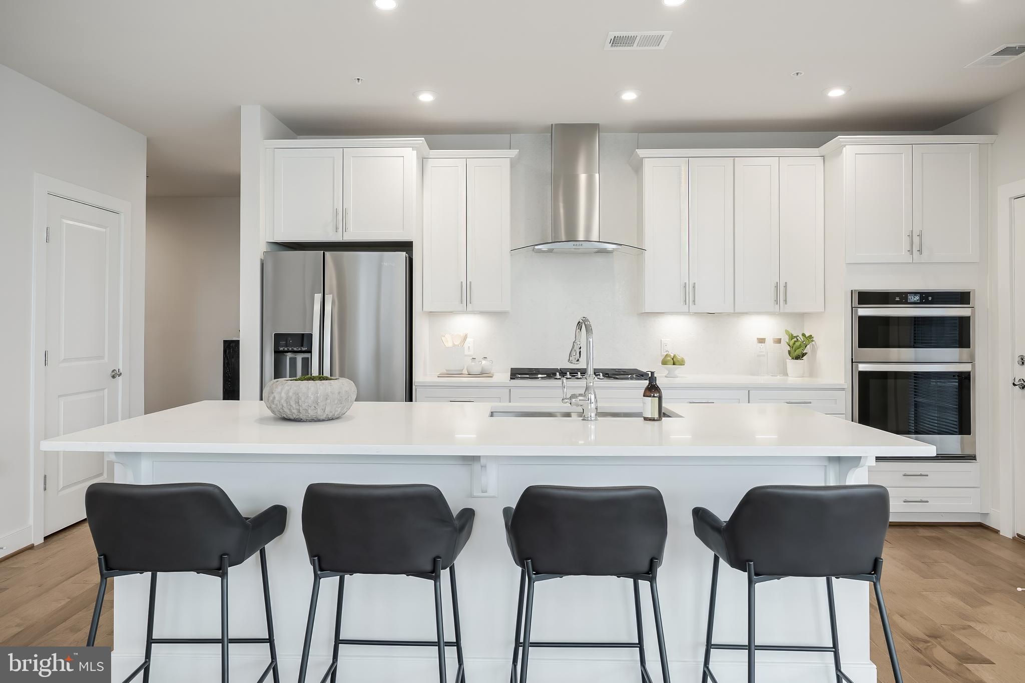 2320 Field Point Road, Unit 201 Herndon, VA 20171 - Photo 1 of 47 a kitchen with stainless steel appliances granite countertop a table and chairs in it
