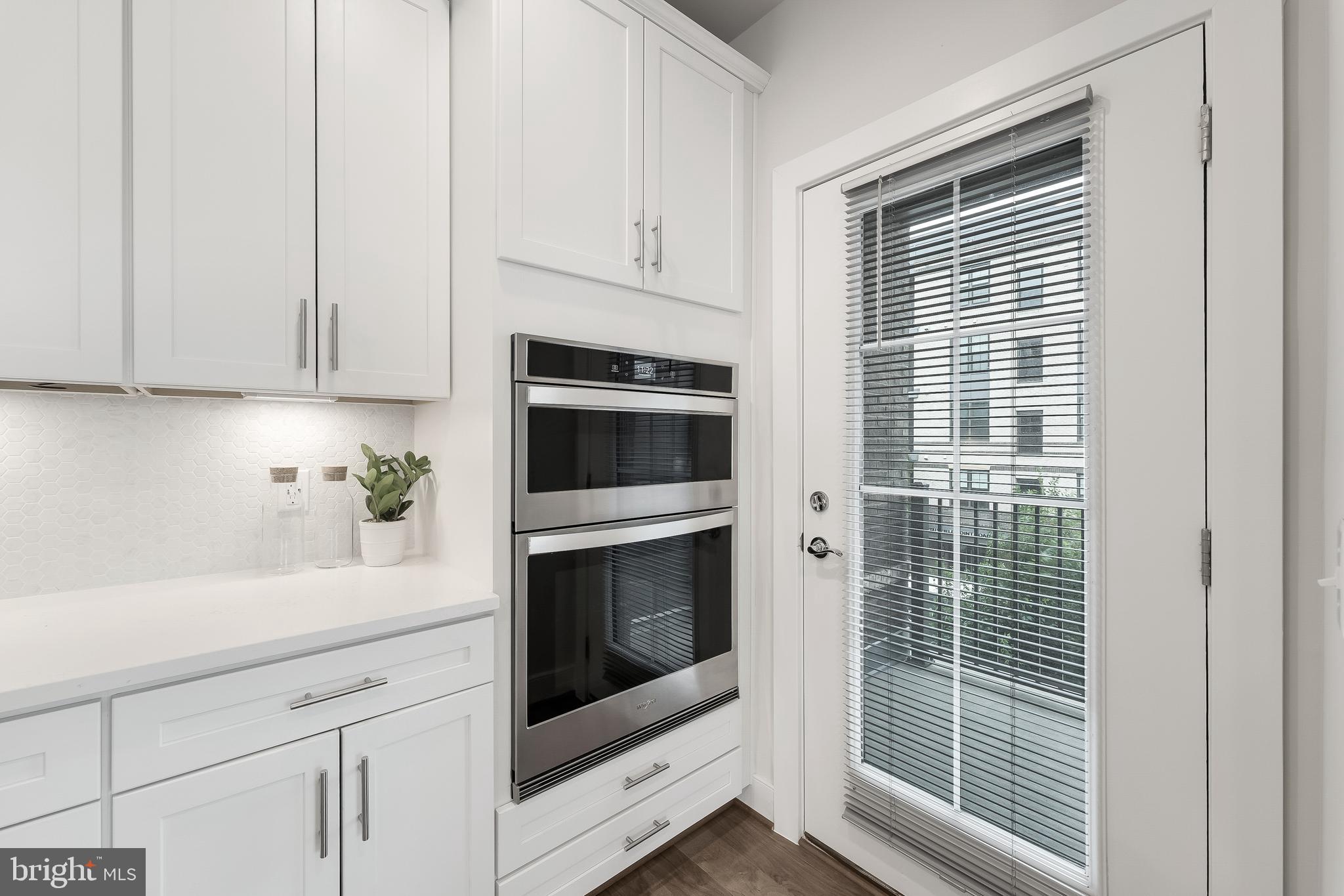 2320 Field Point Road, Unit 201 Herndon, VA 20171 - Photo 12 of 47 a kitchen with white cabinets and a stove