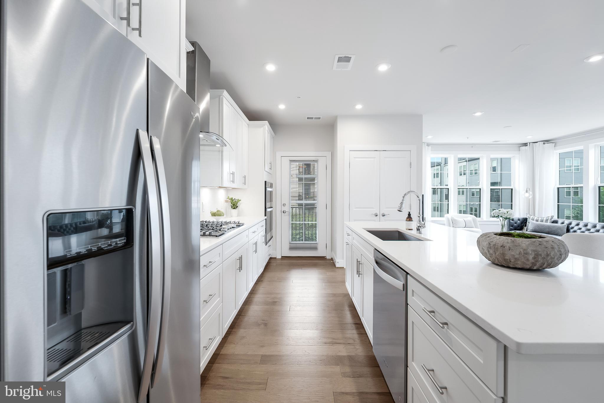 2320 Field Point Road, Unit 201 Herndon, VA 20171 - Photo 13 of 47 a kitchen with white cabinets and stainless steel appliances