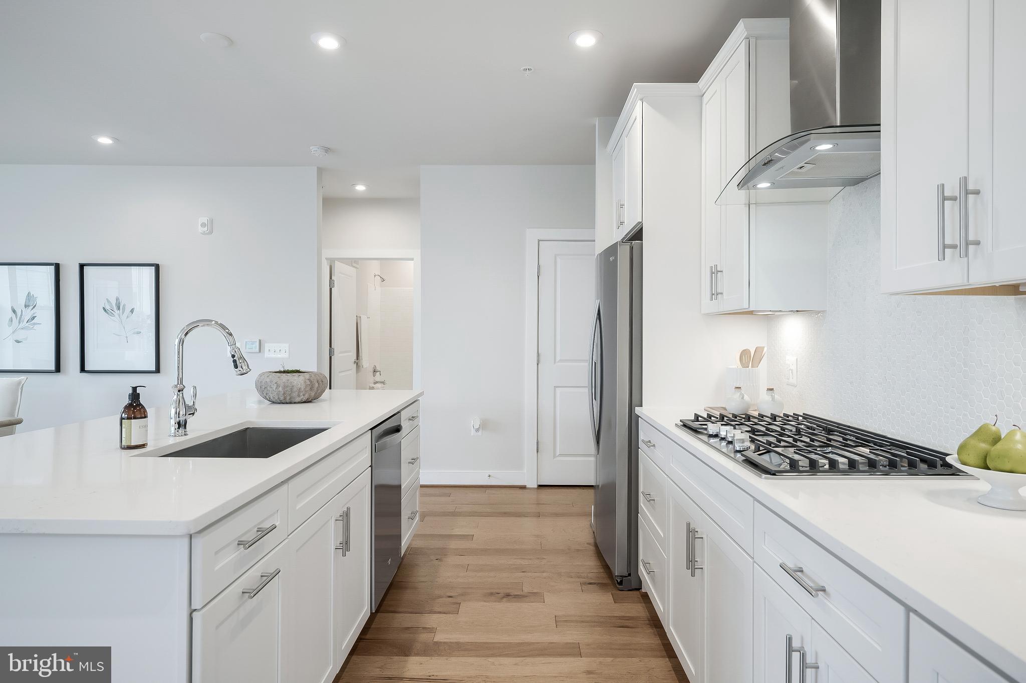 2320 Field Point Road, Unit 201 Herndon, VA 20171 - Photo 14 of 47 a kitchen with stainless steel appliances a sink stove and cabinets