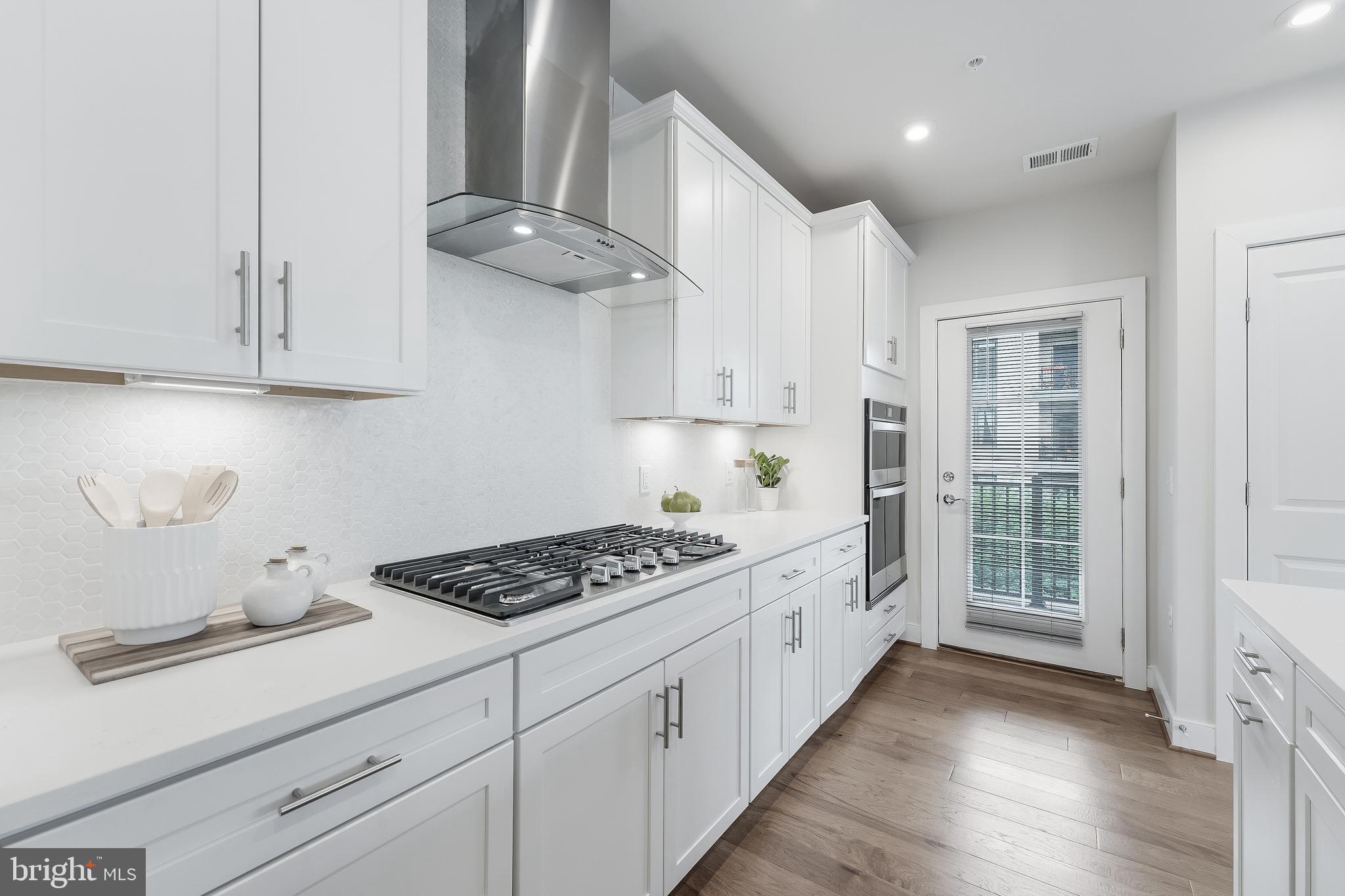 2320 Field Point Road, Unit 201 Herndon, VA 20171 - Photo 15 of 47 a kitchen with stainless steel appliances a white stove top oven and cabinets