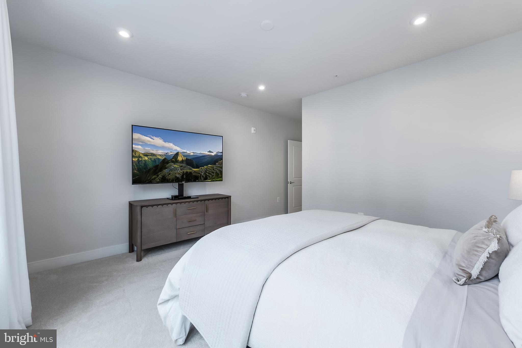 2320 Field Point Road, Unit 201 Herndon, VA 20171 - Photo 29 of 47 a bedroom with a bed and a flat screen tv