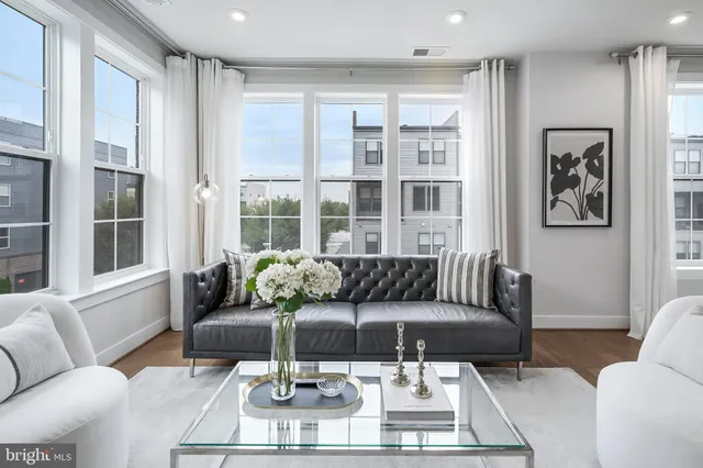 a living room with furniture and a large window