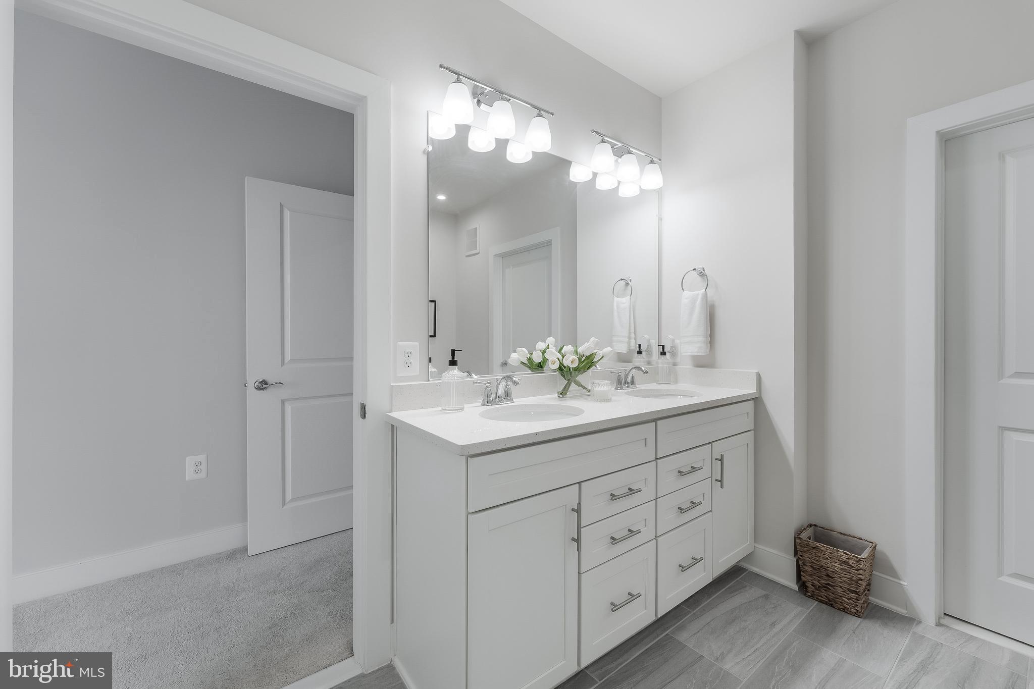 2320 Field Point Road, Unit 201 Herndon, VA 20171 - Photo 31 of 47 a bathroom with a double vanity sink and a mirror