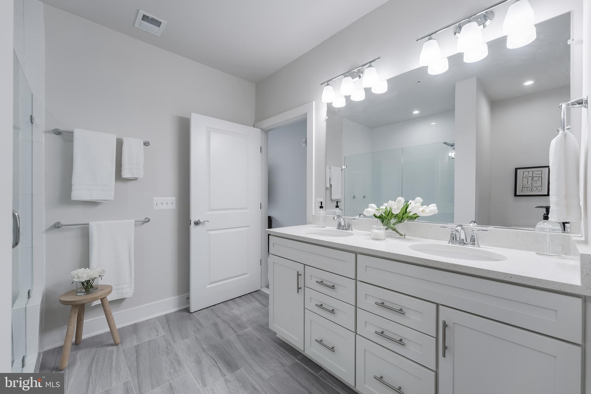 2320 Field Point Road, Unit 201 Herndon, VA 20171 - Photo 32 of 47 a spacious bathroom with a granite countertop sink a toilet and a mirror