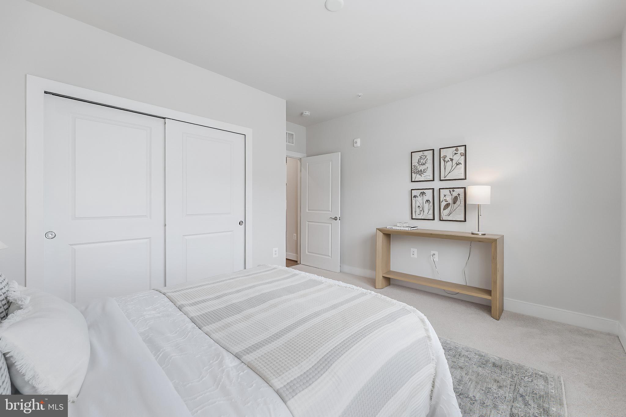 2320 Field Point Road, Unit 201 Herndon, VA 20171 - Photo 36 of 47 a bedroom with a bed and a painting on the wall