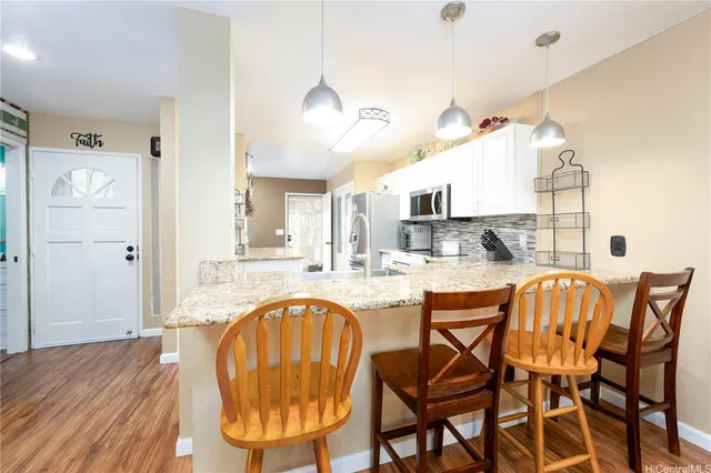 a dining room with furniture and wooden floor