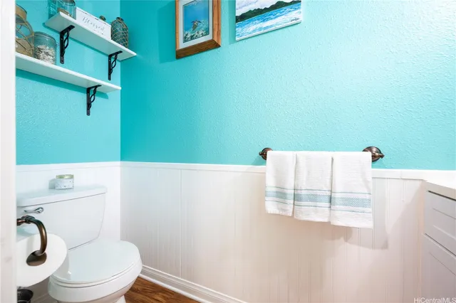 a bathroom with a white toilet and a sink