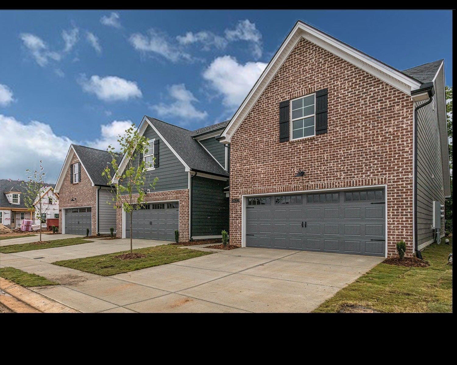 a view of an house with backyard space and a garage