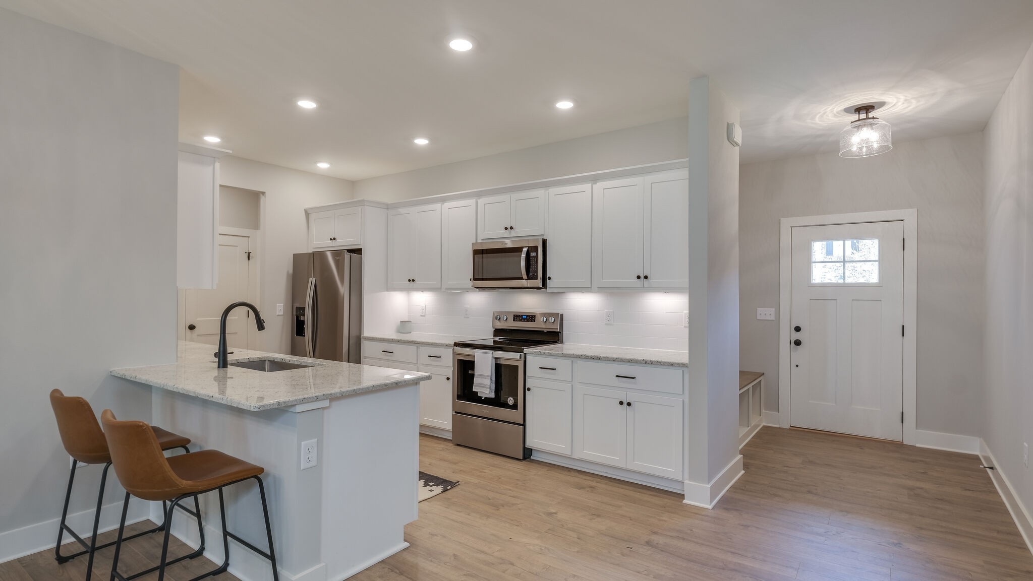 114 Camrose Way Murfreesboro, TN 37128 - Photo 5 of 24 a kitchen with stainless steel appliances granite countertop a sink a stove a refrigerator cabinets and a dining table