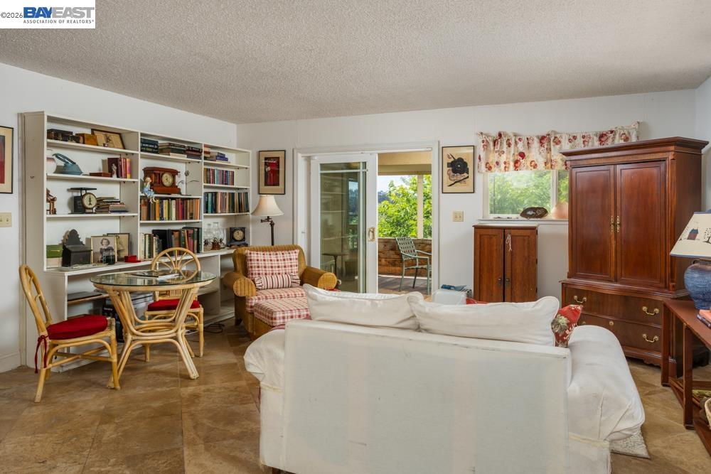 4591 Edwards Lane Castro Valley, CA 94546 - Photo 14 of 44 a living room with furniture a large window and bookshelf