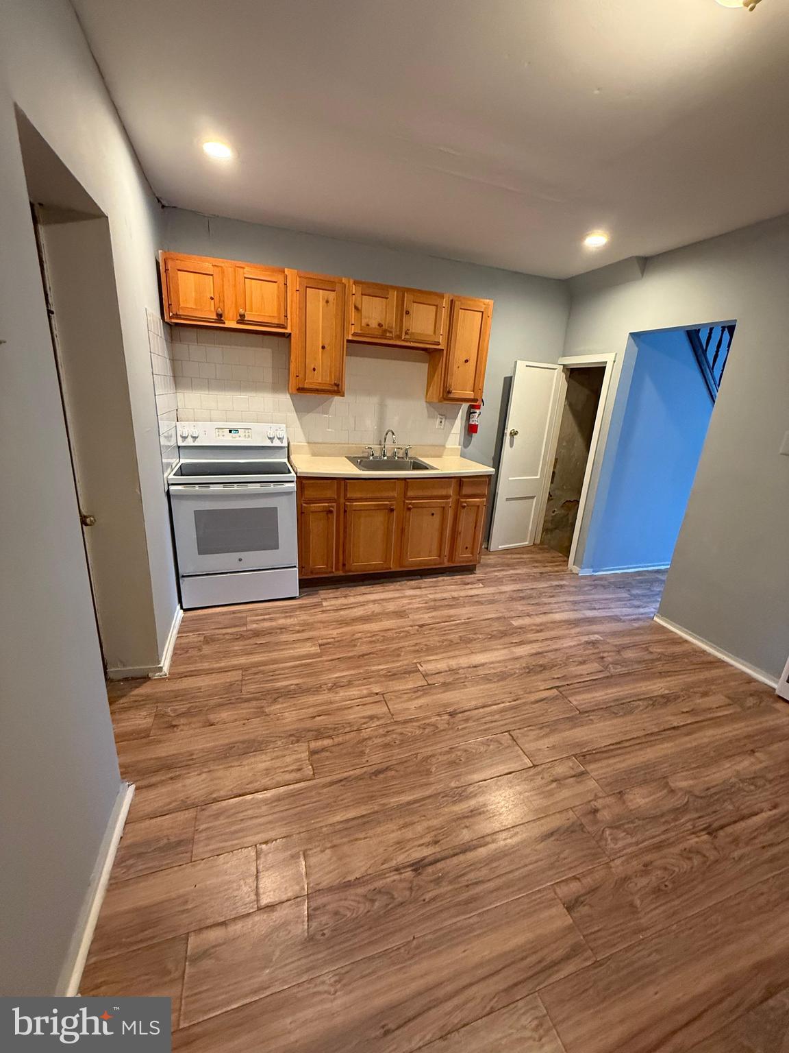 3440 Crystal Street Philadelphia, PA 19134 - Photo 5 of 13 a view of a kitchen with stainless steel appliances wooden floor and a refrigerator