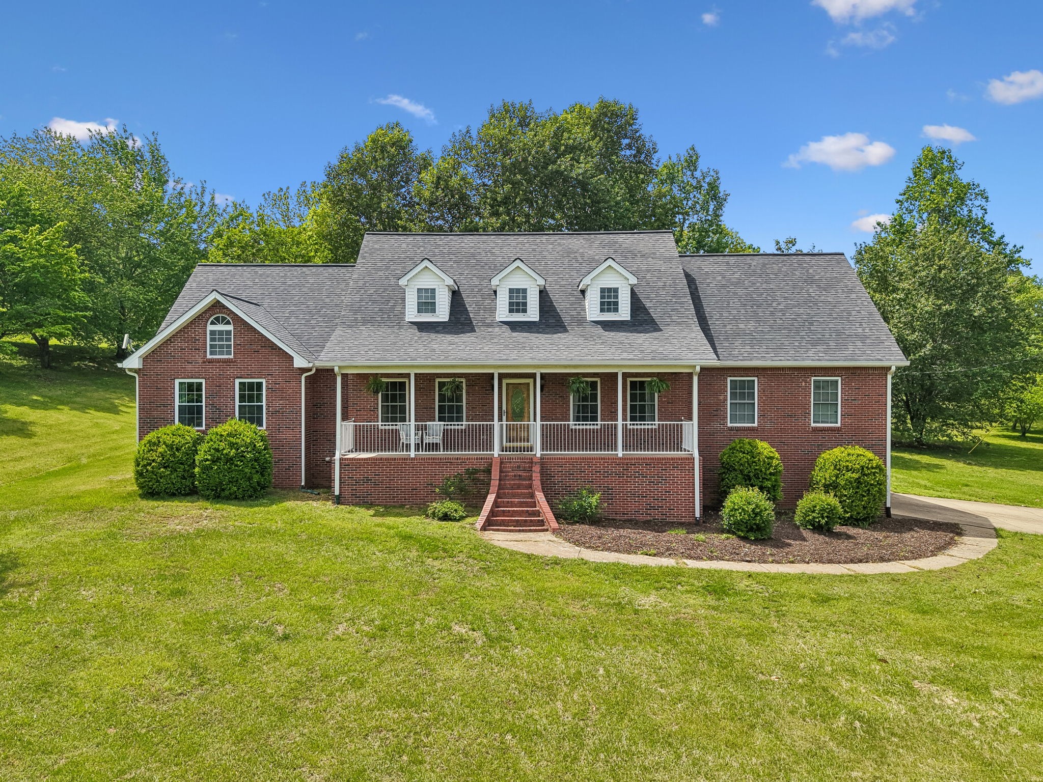 1915 Greenwood Road Charlotte, TN 37036 - Photo 1 of 60 a front view of a house with garden