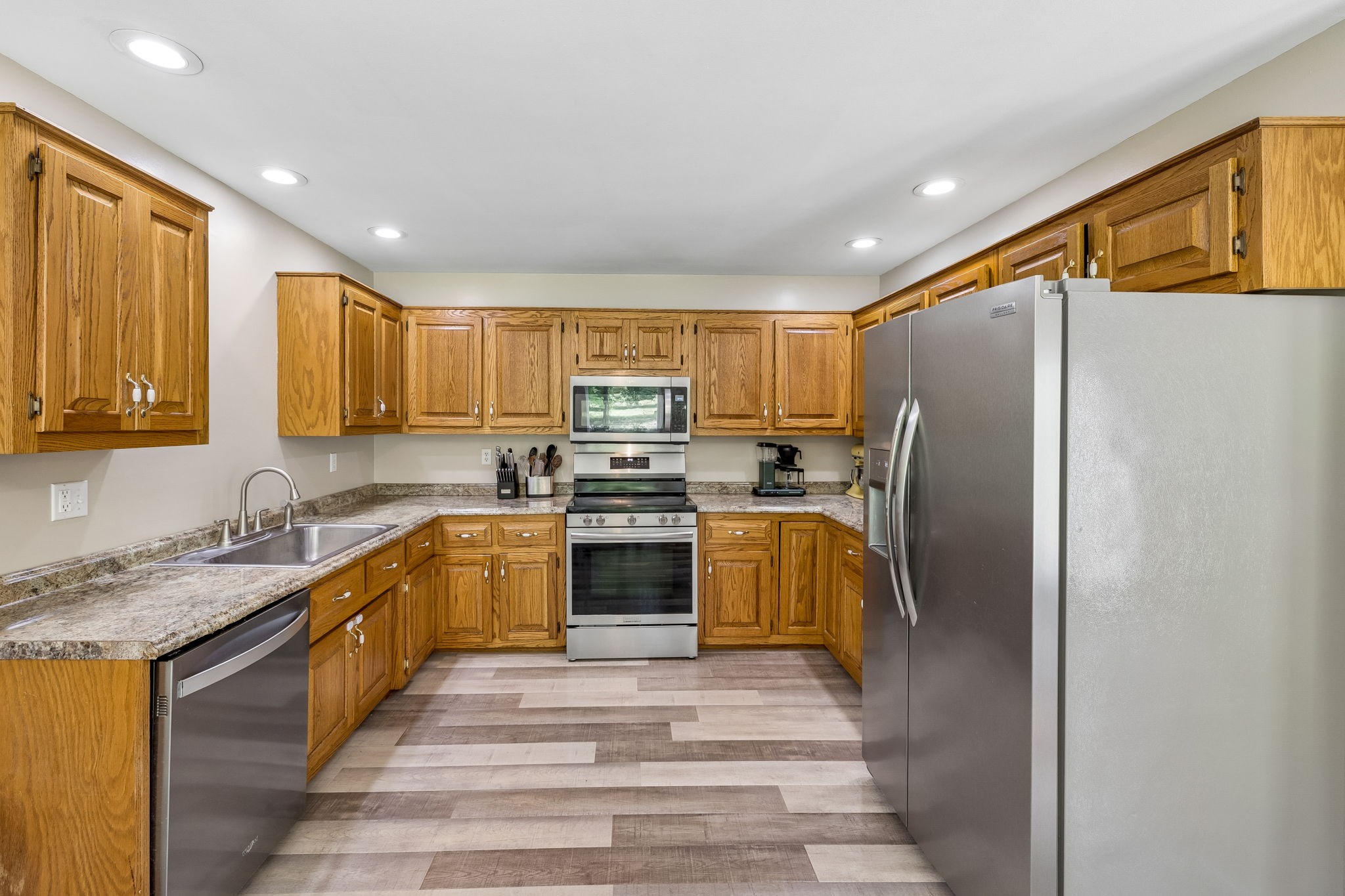 1915 Greenwood Road Charlotte, TN 37036 - Photo 21 of 60 a kitchen with stainless steel appliances granite countertop a refrigerator sink and stove