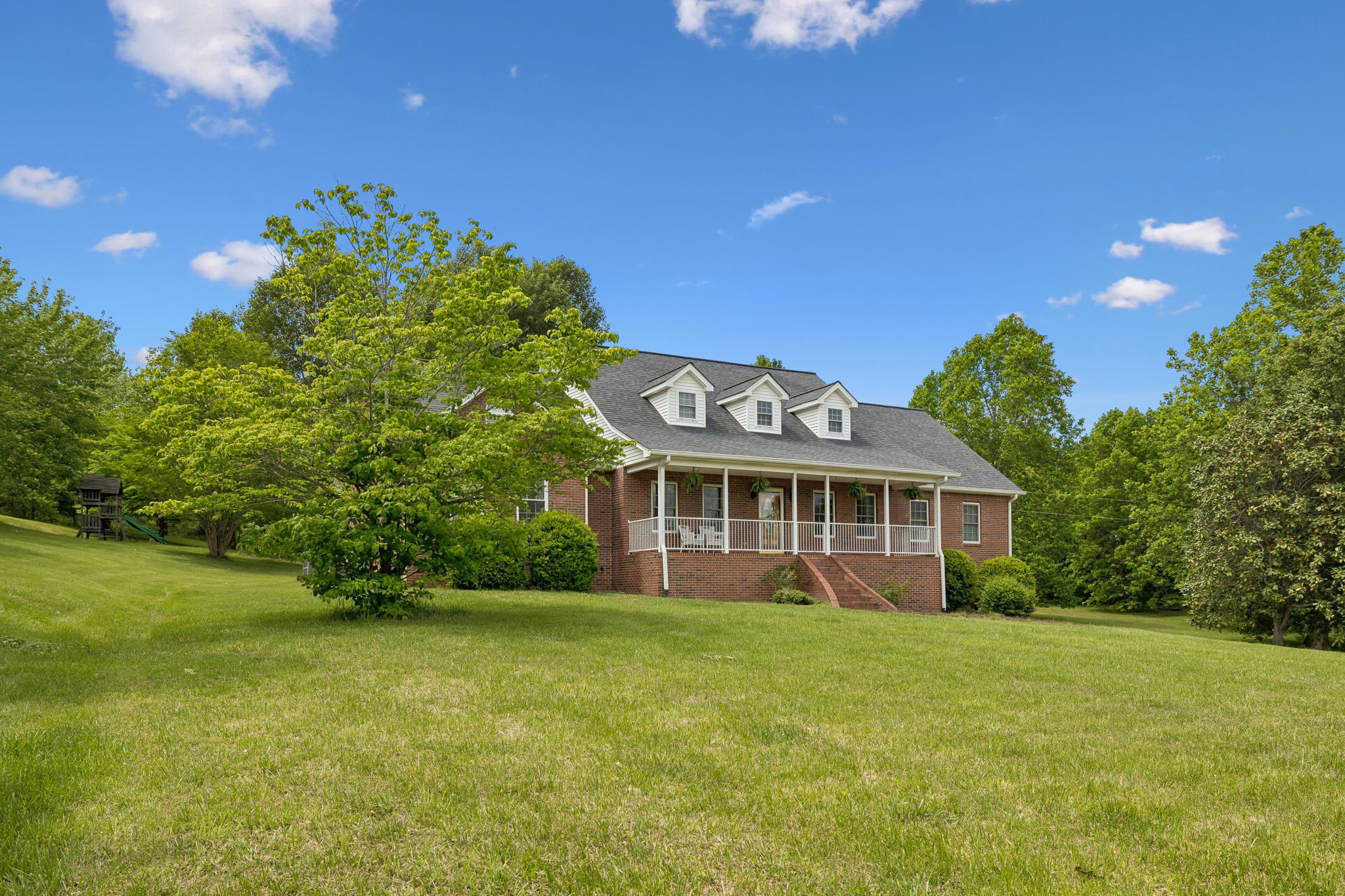 1915 Greenwood Road Charlotte, TN 37036 - Photo 53 of 60 a front view of a house with a garden