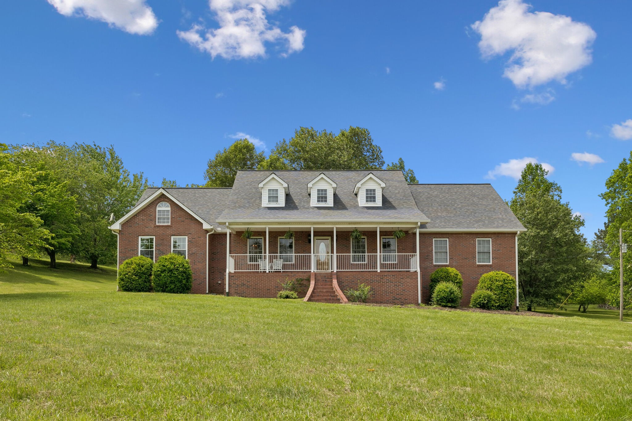 1915 Greenwood Road Charlotte, TN 37036 - Photo 6 of 60 a view of a house with a big yard and large trees