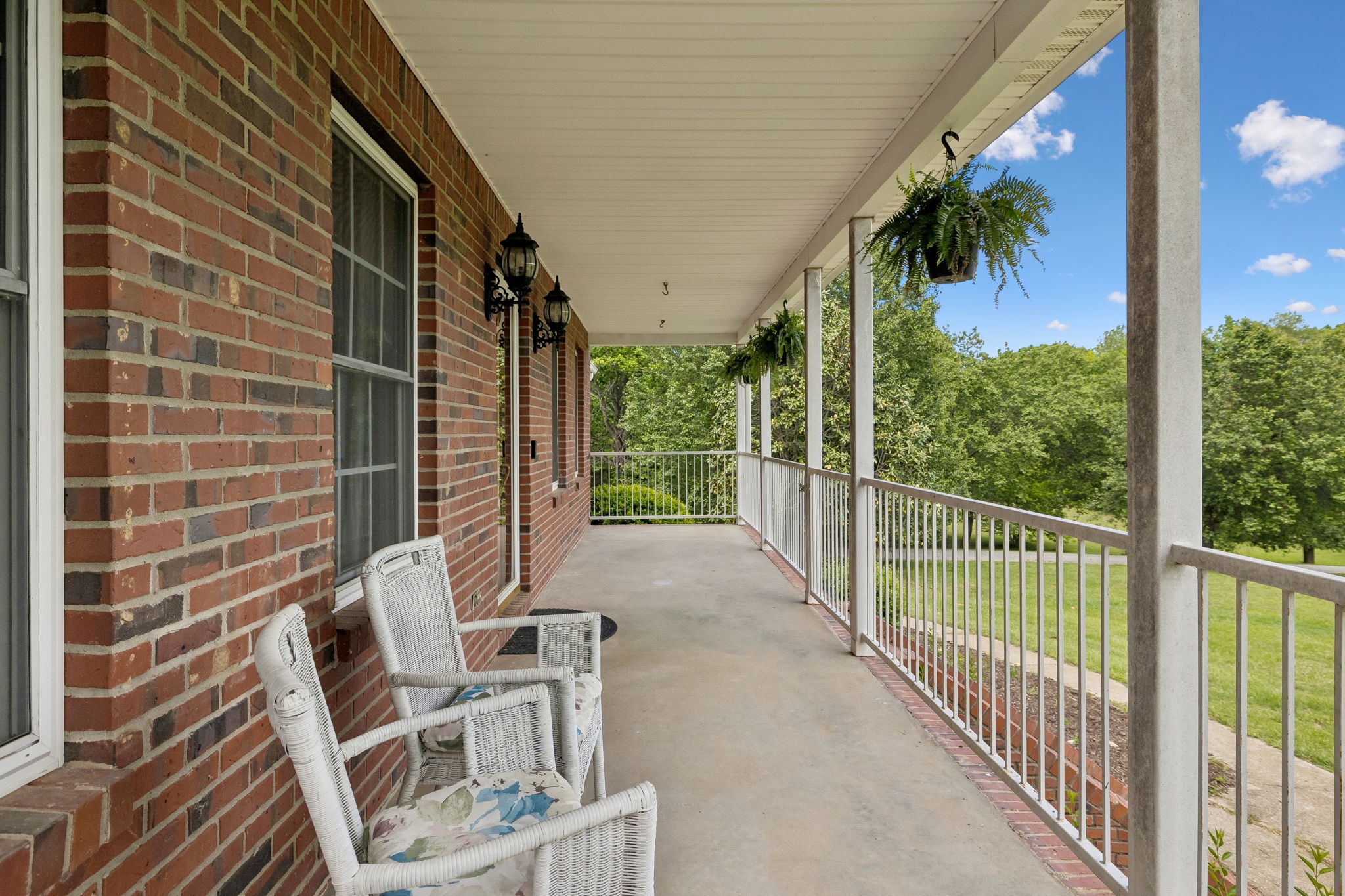 1915 Greenwood Road Charlotte, TN 37036 - Photo 7 of 60 a view of a porch with wooden floor and outdoor seating