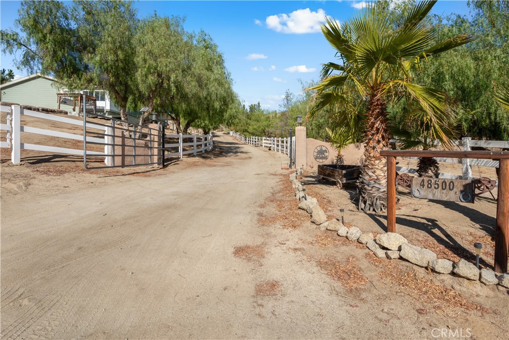 48500 Aguanga Ranchos Road Aguanga, CA 92536 - Photo 1 of 1 Entry to the estate with an electric gate. Showing off the beautiful driveway to the homes.