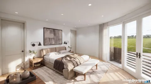 a bedroom with a large bed and a large window