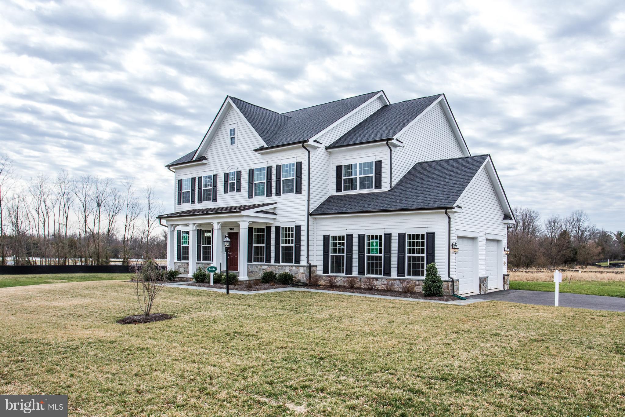 17027 Bennett Way Poolesville, MD 20837 - Photo 1 of 3 a front view of a house with a yard
