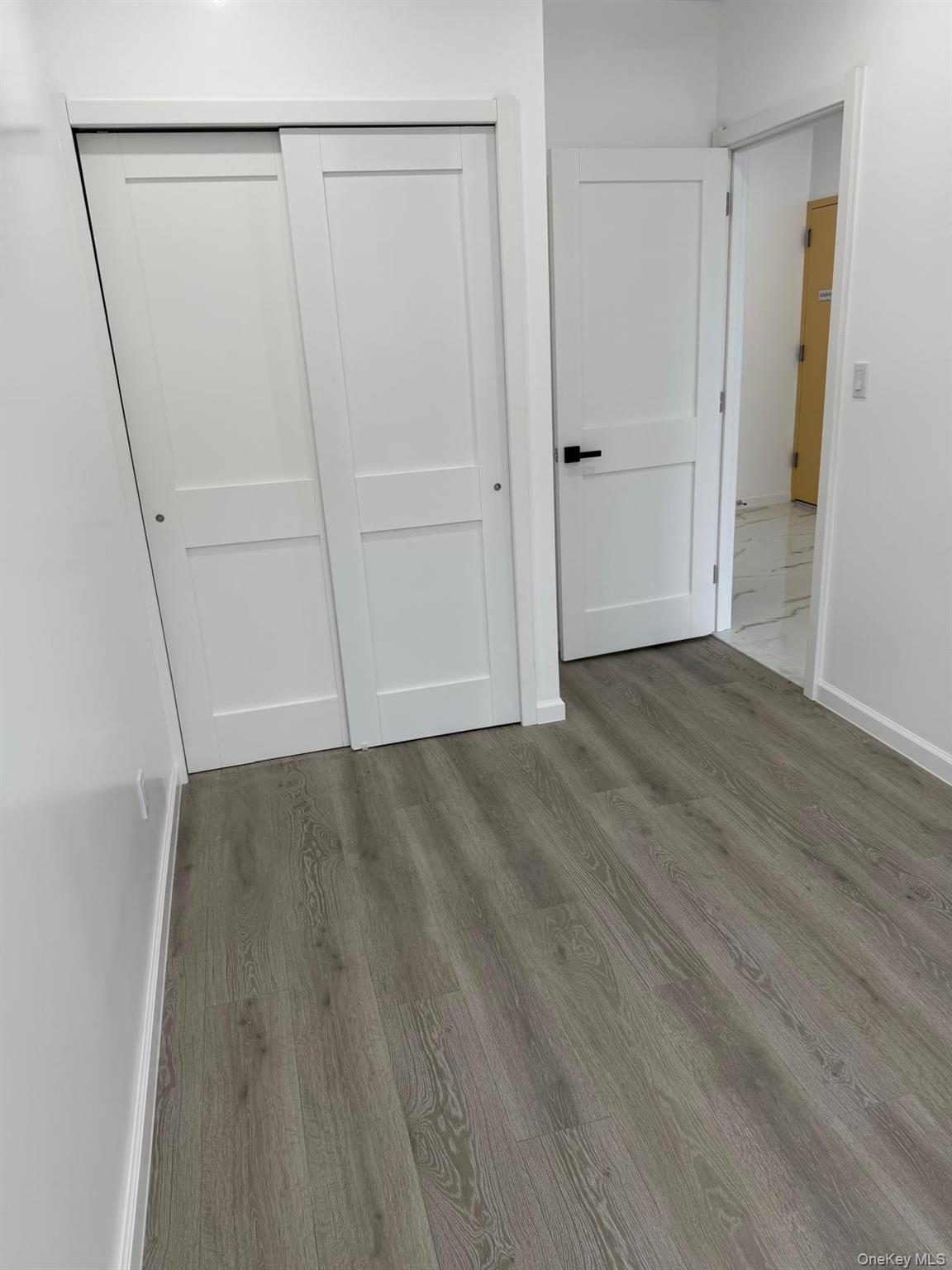 86-05 Britton Avenue, Unit 2 Queens, NY 11373 - Photo 6 of 7 a view of an empty room with wooden floor