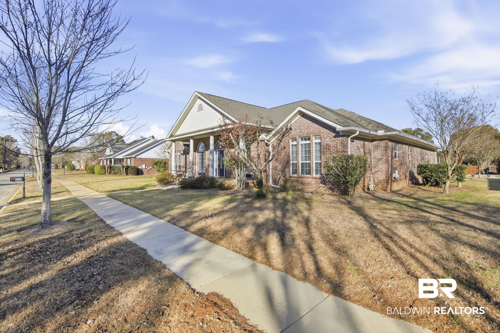 29634 St George Street Daphne, AL 36526 - Photo 4 of 47 View of front facade featuring covered porch, brick siding, and a front lawn
