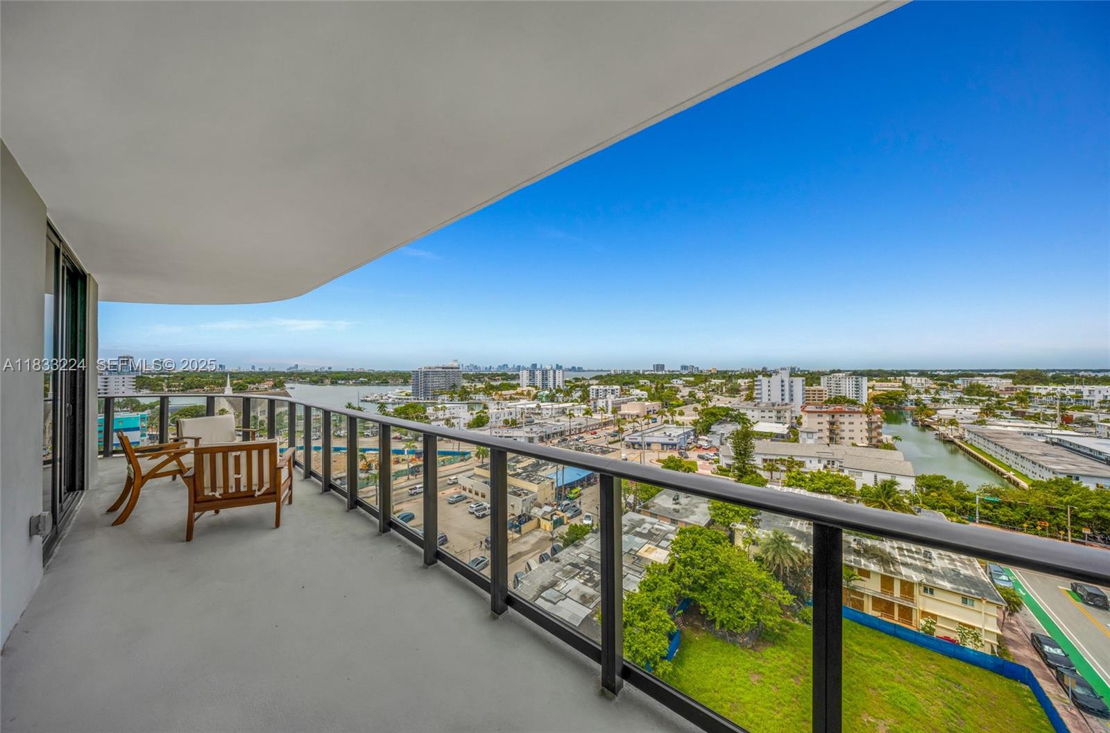 580 72nd Street, Unit 910 Miami Beach, FL 33141 - Photo 43 of 60 a view of a balcony with chairs and wooden floor