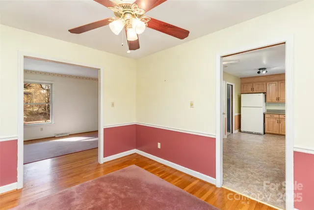 a view of a room with wooden floor and cabinet