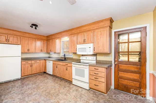 a kitchen with a stove a sink and a refrigerator