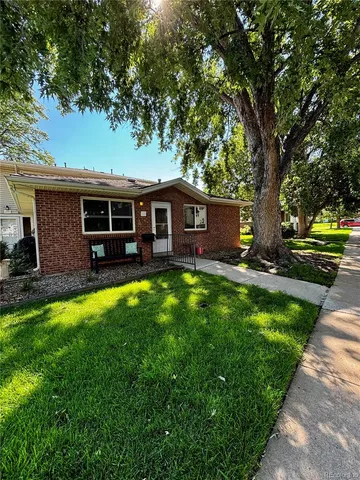 a view of a house with a backyard porch and sitting area